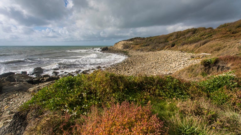 A breezy pebbly beach on a grey autumn day at Water Shoot Bay at the southern tip of the Isle of WIght